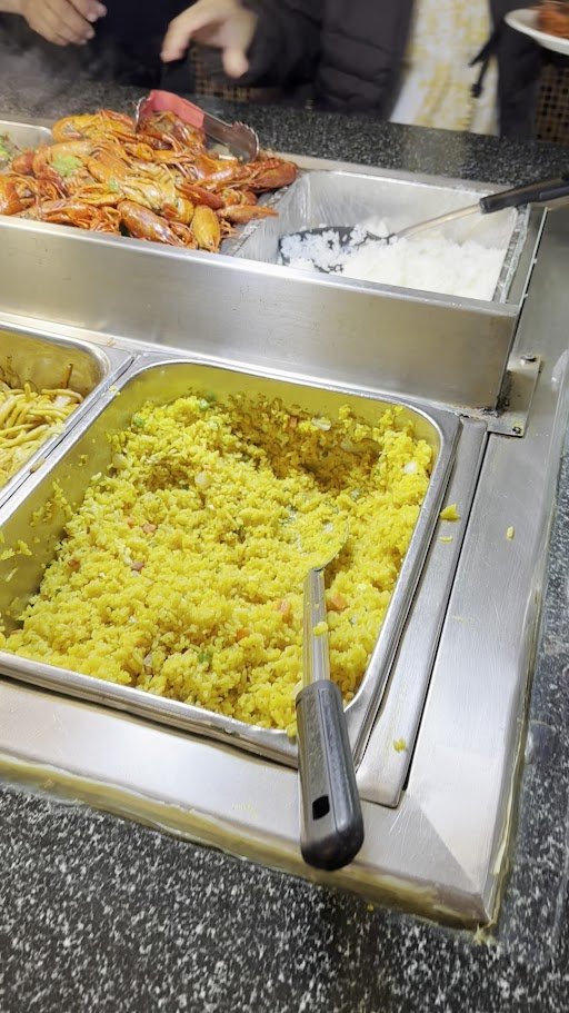 Buffet tables with trays of seafood dishes.